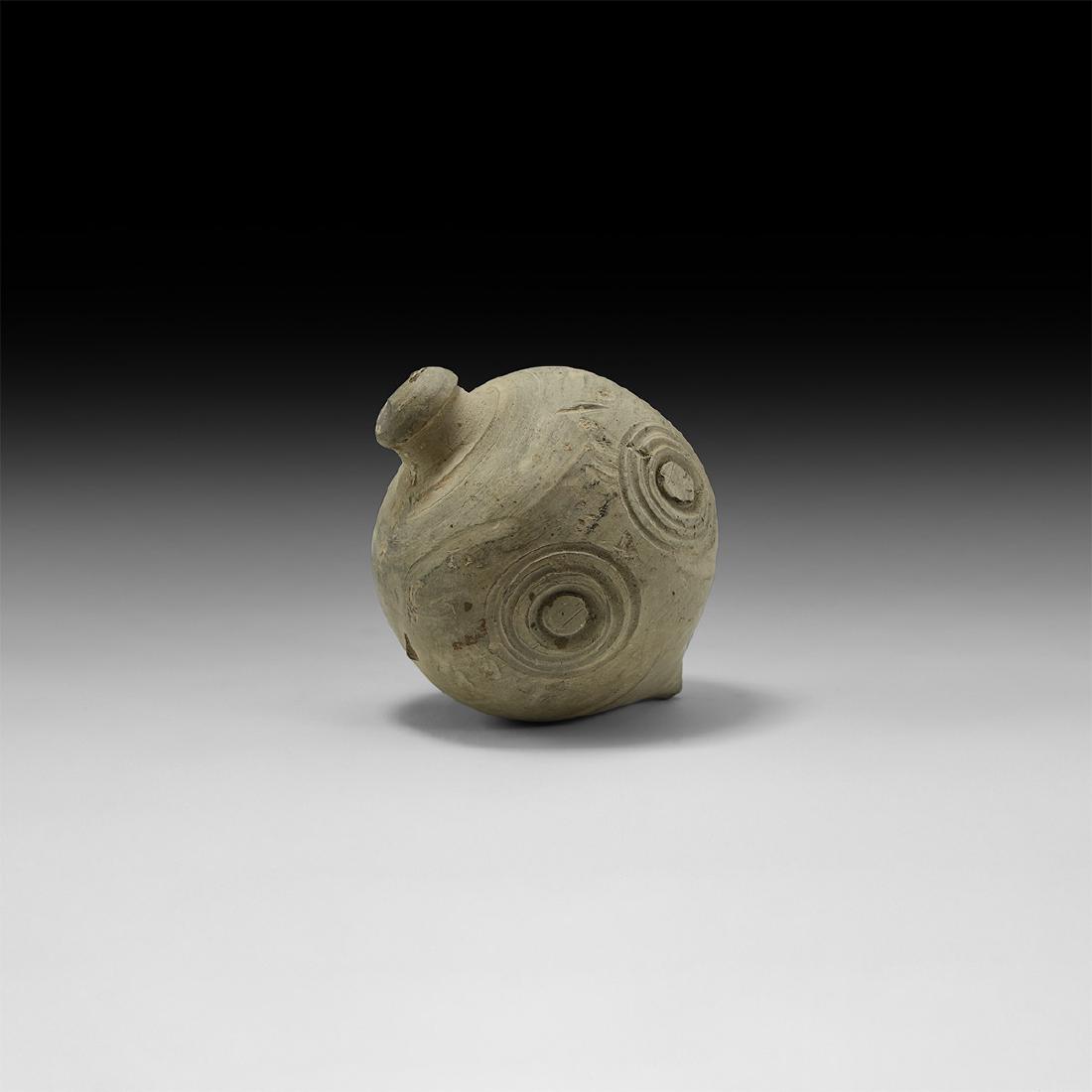 Byzantine 'Greek Fire' Fire Bomb or Hand Grenade: 9th-11th century AD. A large hollow ceramic vessel with bulbous body and conical base, intended to be filled with explosive liquid and a wick, and used as a hand grenade; the body decorated with serie