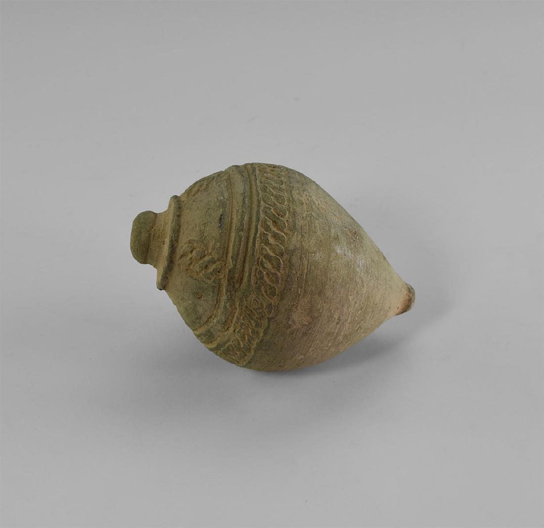 Byzantine 'Greek Fire' Fire Bomb or Hand Grenade: 9th-11th century AD. A hollow ceramic vessel with domed top and conical base, intended to be filled with explosive liquid and wick, used as a hand grenade; shoulder with band of scrolls with further f