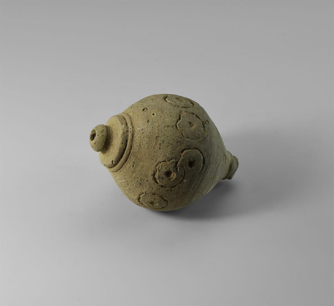 Byzantine 'Greek Fire' Fire Bomb or Hand Grenade: 9th-11th century AD. A hollow ceramic vessel with domed top and conical base, intended to be filled with explosive liquid and wick, used as a hand grenade; incised annulet-and ring decoration to the s