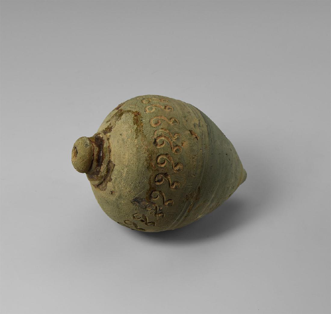 Byzantine 'Greek Fire' Fire Bomb or Hand Grenade: 9th-11th century AD. A very large hollow ceramic vessel with domed top and conical base, intended to be filled with explosive liquid and wick, used as a hand grenade; the body with circumferential lin