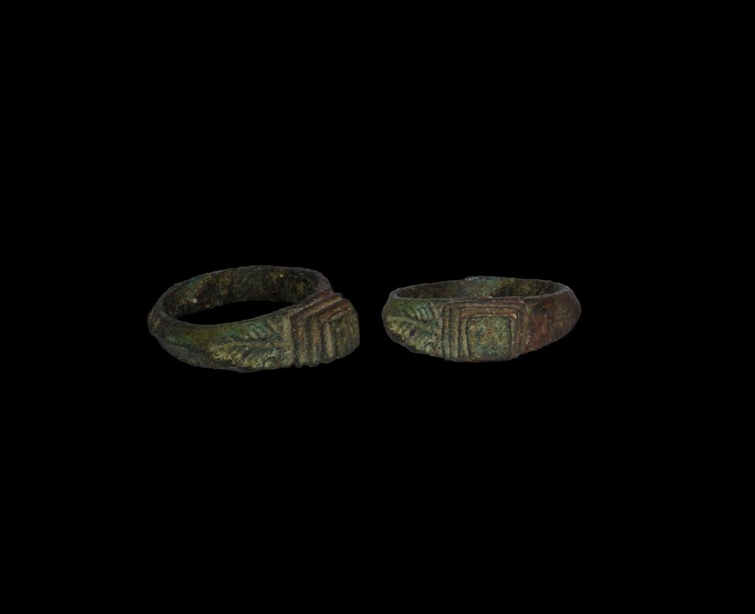 Merovingian Ring with Stepped Bezel: 5th-6th century AD. A bronze ring with keeled hoop, angled shoulders with engraved leaf-motif, the bezel formed as a stepped pyramid. 5.29 grams, 26.56mm overall, 18.40mm internal diameter (approximat