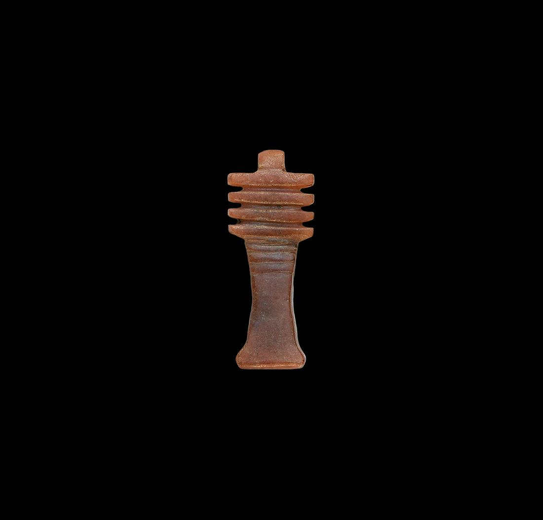 Egyptian Carnelian Djed Pillar Amulet: New Kingdom, 1550-1070 BC. A carved carnelian amuletic pendant of the djed pillar, pierced through the dorsal column for suspension. 0.77 grams, 20mm (2/3"). From a UK collection; formerly in an early