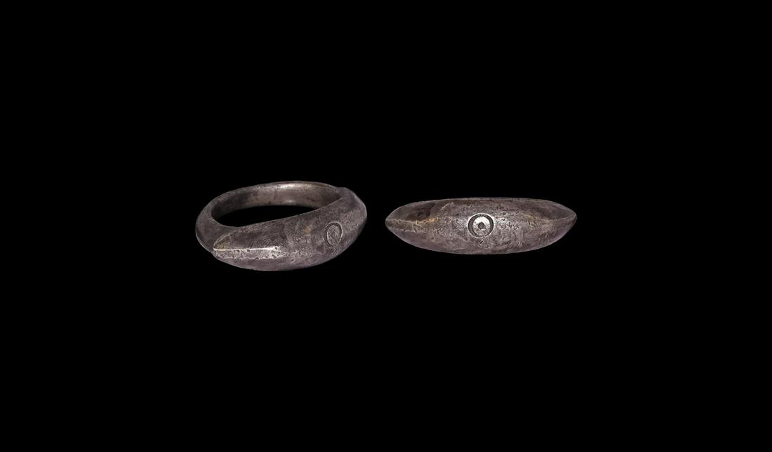 Roman Silver Ring with 'Bull's Eye': 3rd century AD. A silver finger ring comprising a D-section hoop with keeled and stepped shoulders, curved bezel with with incised ring-and-dot motif. Cf. Ruseva-Slokoska, L. Roman Jewellery, Sofia, 1