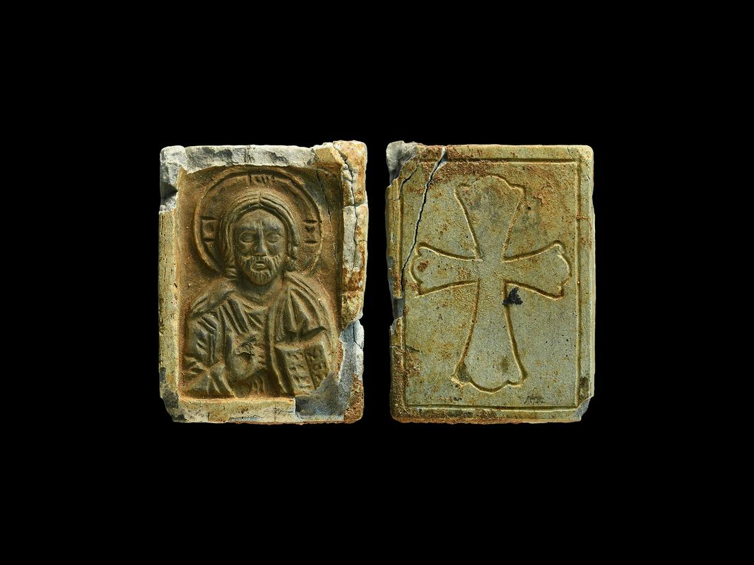 Byzantine Icon of Christ: 12th-14th century AD. A carved steatite icon in a rectangular frame, low-relief bust of Christ nimbate with right hand in attitude of blessing, left hand supporting a book. 7.90 grams, 30mm (1 1/4"). 