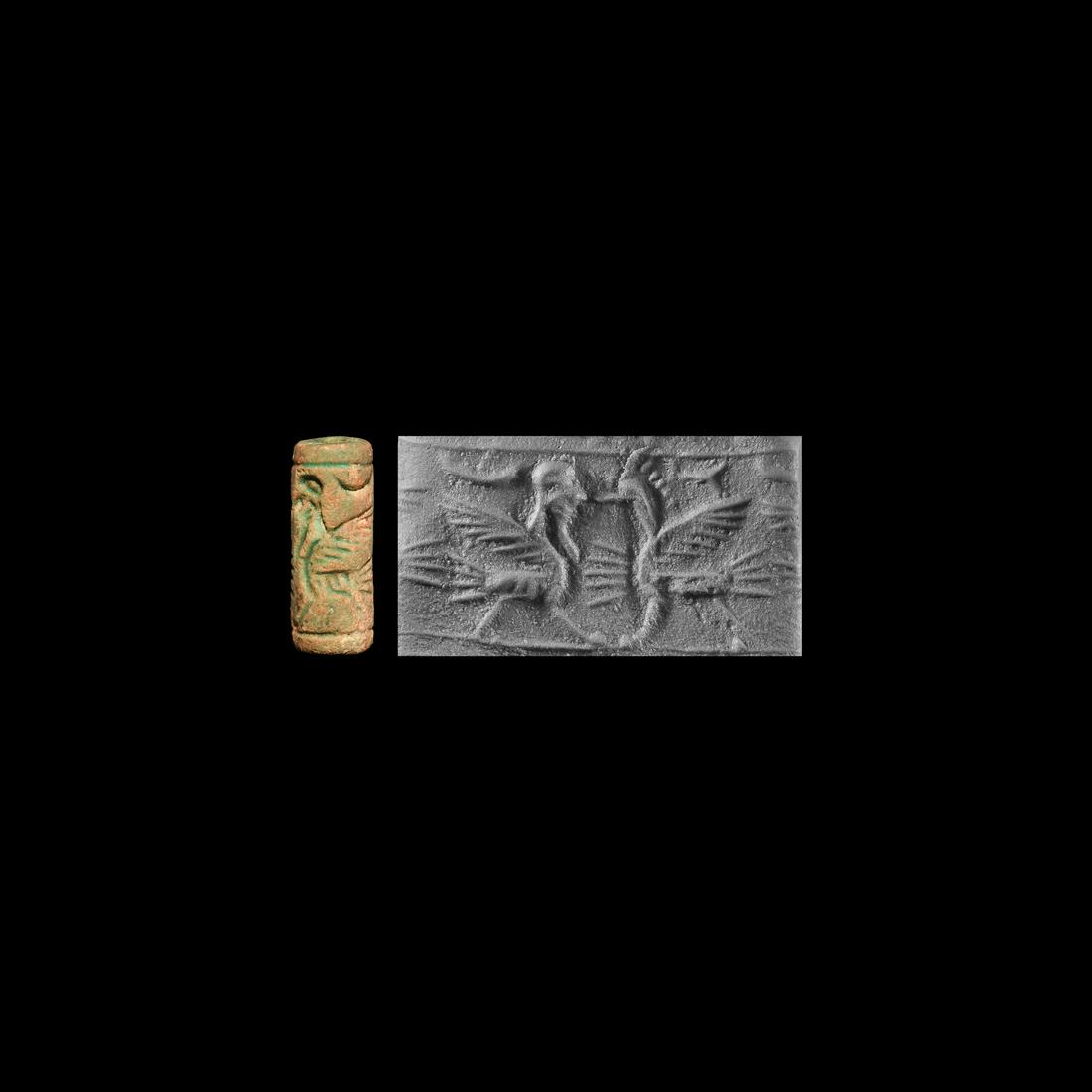 Western Asiatic Cylinder Seal with Gryphons: 2nd millennium BC. A pale green limestone cylinder seal with opposed gryphons design. 2.64 grams, 23.69mm (1"). From the private collection of a North West London lady; previously with a central Londo