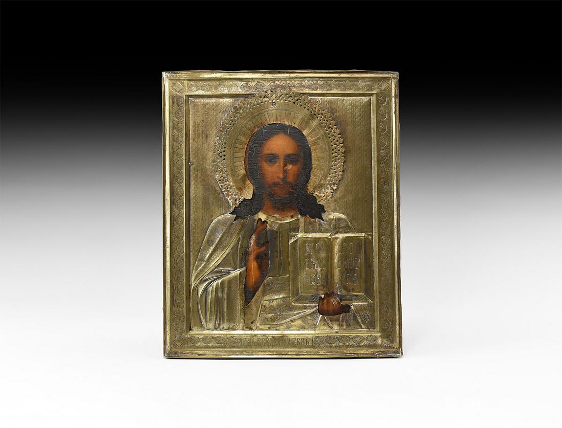 Russian Icon with Christ: 19th century AD. A rectangular icon painted in tempera on a wooden panel depicting Christ facing in a repoussé silver-coloured metal riza (oklad) with border and title inscription, Christ in draped m