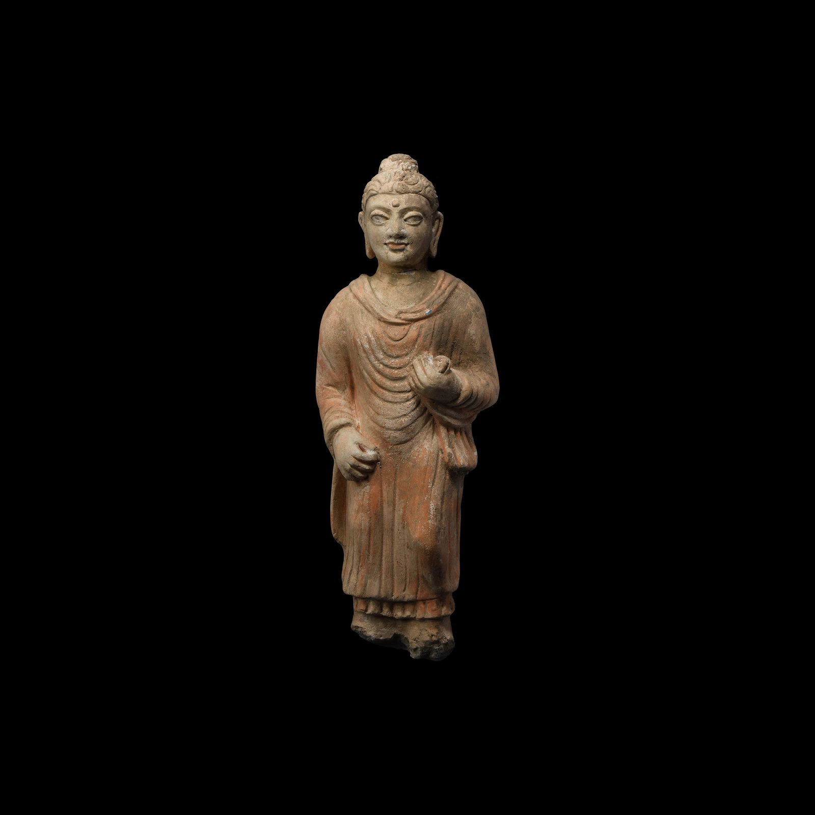 Gandharan Stucco Figure: 4th-5th century AD. A stucco figure of Buddha modelled in the half-round standing wearing a loose robe, original pigment to the surface. 1.3 kg, 34cm (13 1/2"). From a North West London collection; pr