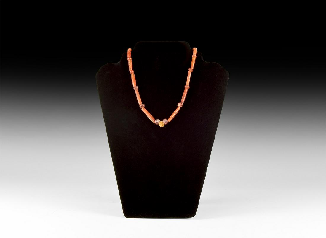 Parthian Carnelian Necklace with Gold Melon Bead: 1st millennium BC. A restrung necklace of cylindrical and oblate carnelian beads and median gold melon bead; modern clasp. 21 grams, 41cm (16"). Private collection, London, UK; formerly with Persepoli