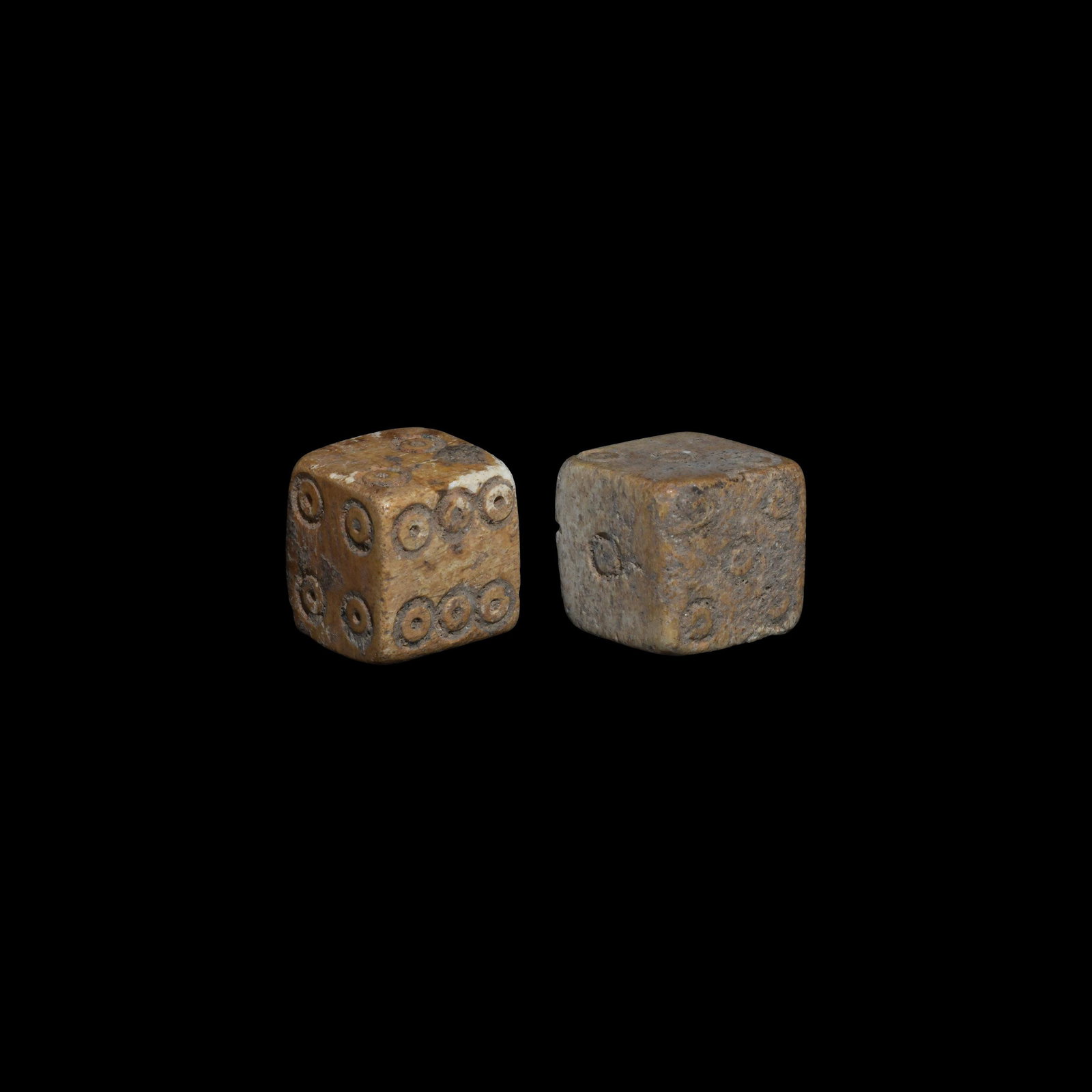 Roman Bone Dice Pair: 1st-2nd century AD. A matched pair of bone cuboid dice with ring-and-dot markings disposed 1:6, 2:5, 3:4. 4.83 grams total, 11mm (1/2"). Property of a Bristol collector; formerly part of his father's 