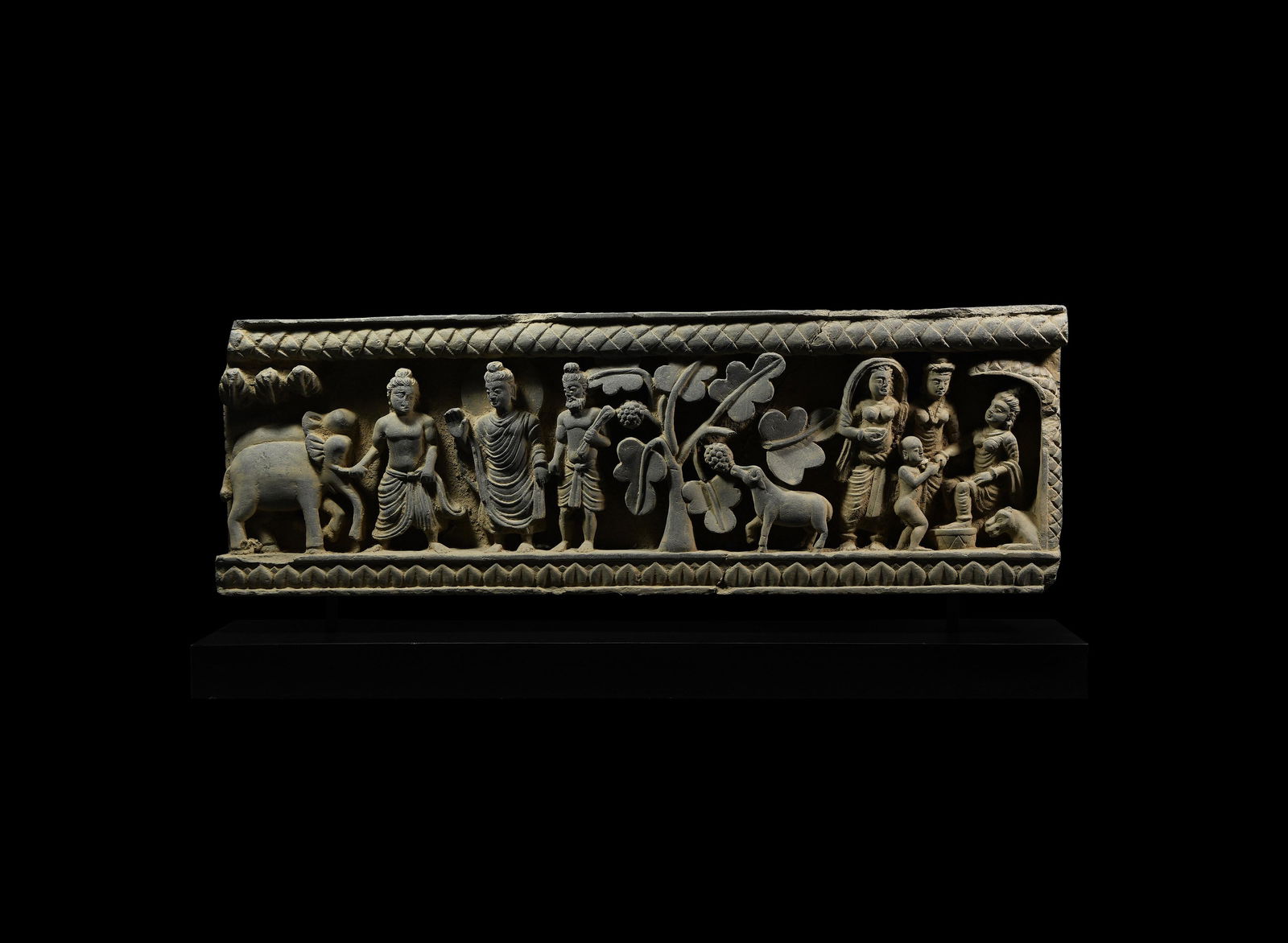 Gandharan Schist Frieze Panel: 2nd-3rd century AD. The Buddha's experiences in the rural landscape are evinced in this carved schist frieze in which the teacher appears, facing a nimbate figure wearing a loosely draped robe hanging