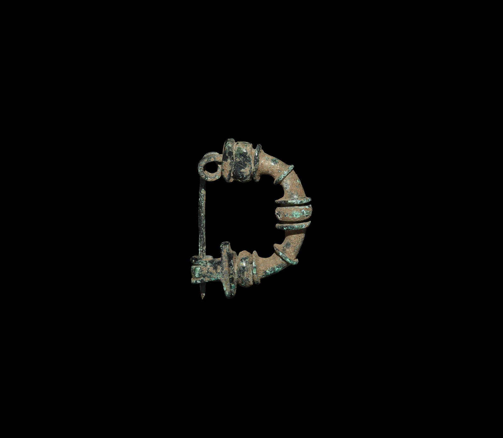 Greek Bow Brooch: Mid 1st millennium BC. A bronze brooch comprising an arched shank with ribbed sleeves, coiled spring and integral pin, catch formed as a hand. Cf. Hattatt, R. Ancient Brooches and Other Artefacts, Oxf