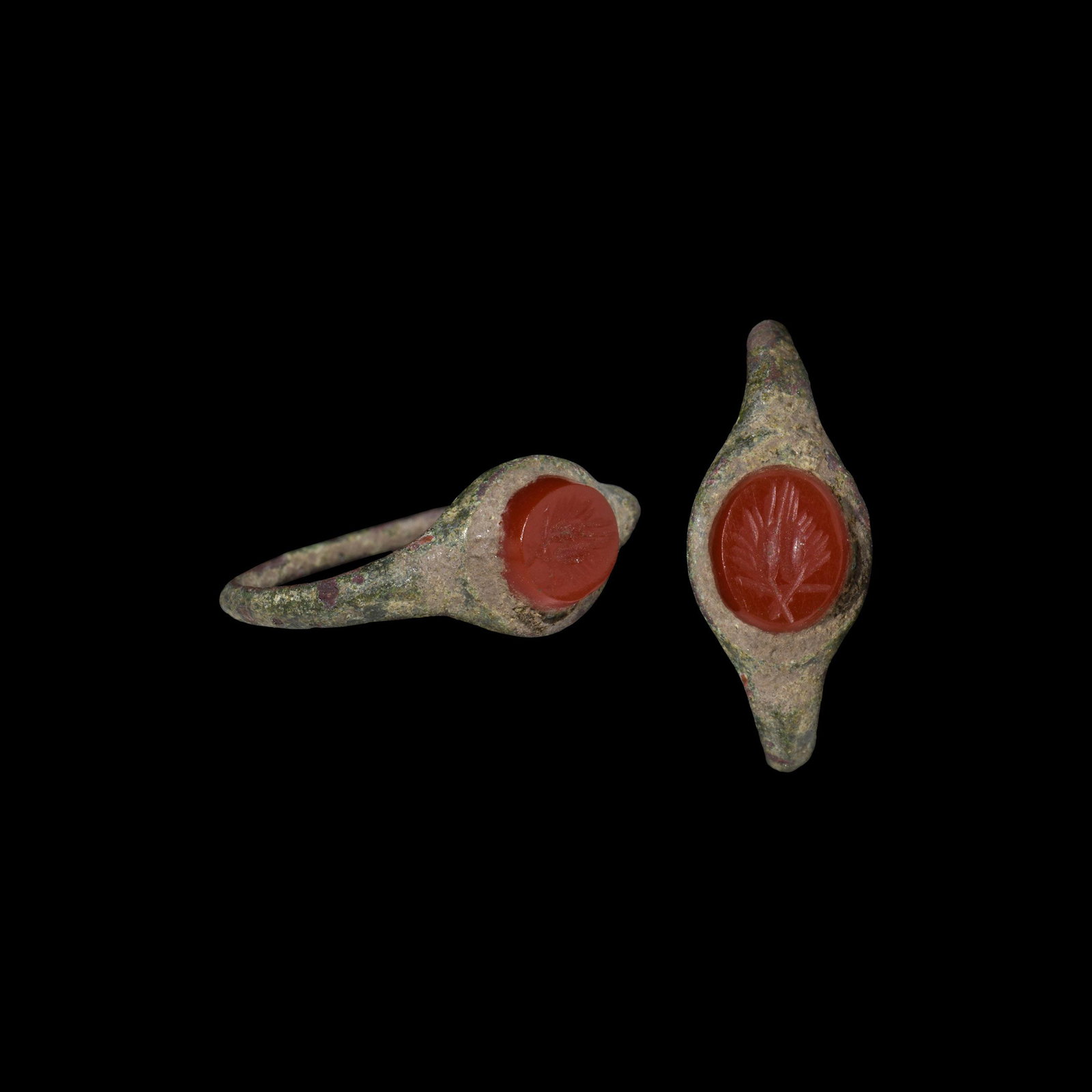 Roman Ring with Ears of Wheat: 2nd century AD. A slender bronze finger ring with ellipsoid bezel inset jasper gemstone with intaglio two ears of wheat. Cf. Chadour, A.B. Rings. The Alice and Louis Koch Collection, volume I, Leeds, 