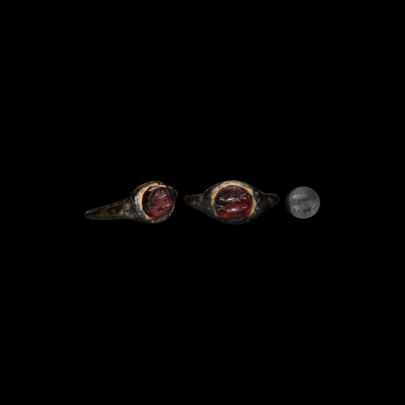Roman Ring with 'Pisces' Gemstone: 1st-2nd century AD. A bronze finger ring with slender hoop, plaque with inset carnelian intaglio of two fish, astrological sign for Pisces. Cf. Ruseva-Slokoska, L. Roman Jewellery, Sofia, 1991, item 2