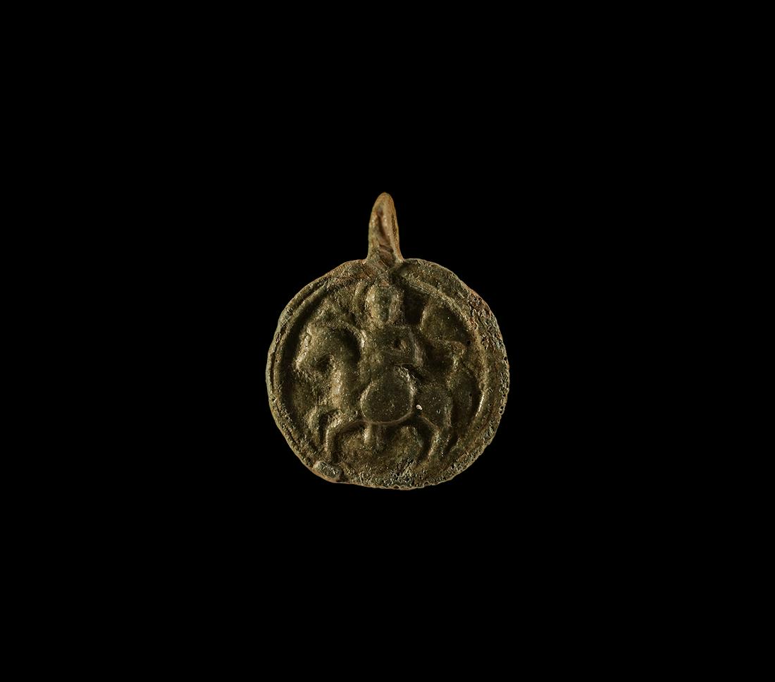 Byzantine Pendant with St Michael: 10th-13th century AD. A bronze discoid pendant with pierced lug above, low-relief image of St Michael as an armoured horseman with lance and wings spread. 2.4 grams, 25mm (1"). Private collection, Cam