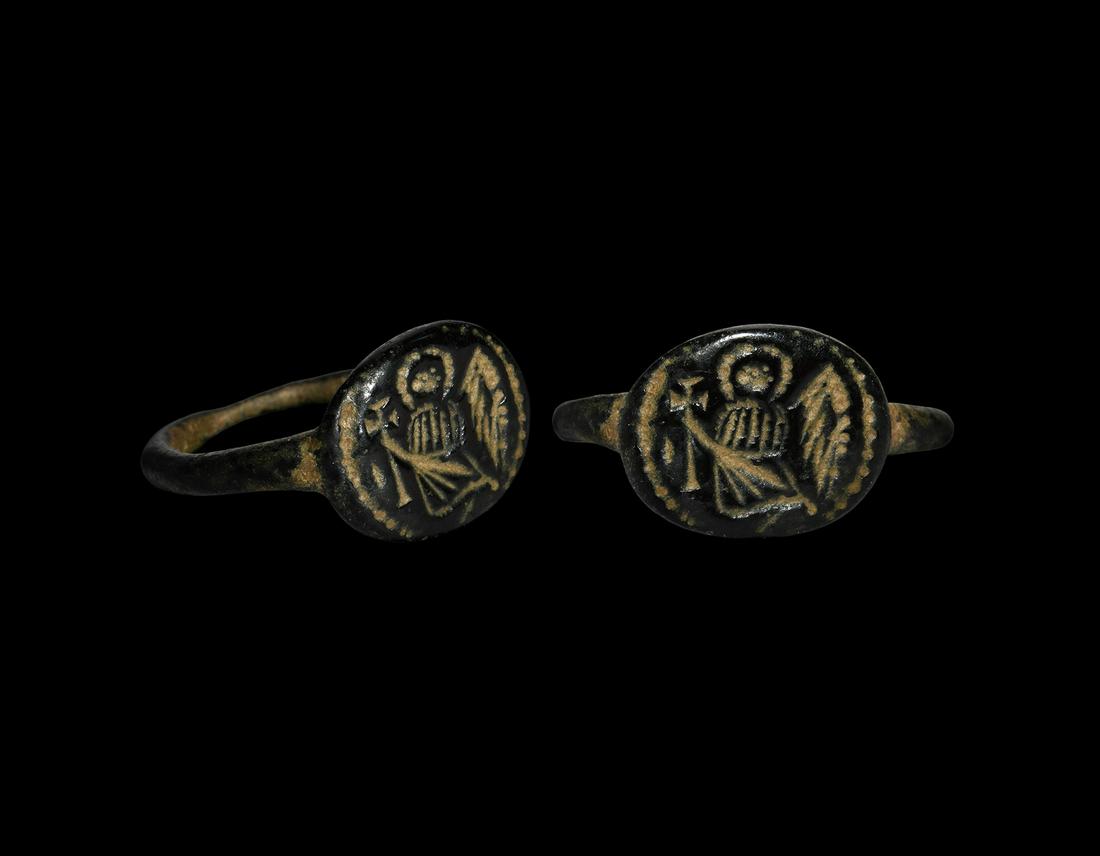 Byzantine Ring with Angel: 6th-7th century AD. A bronze finger ring with ellipsoid bezel, intaglio winged nimbate angel with cross within a beaded border. Cf. Chadour, A.B. Rings. The Alice and Louis Koch Collection, volume I, 