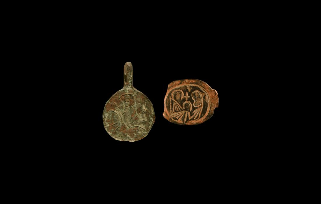 Byzantine Pendant and Bezel Group: 6th-8th century AD. A mixed bronze group comprising: a bezel with two nimbate figures flanking a cross; a discoid pendant with nimbate figure to the obverse, 'TS/KAT' to the reverse. 4.03 grams total,