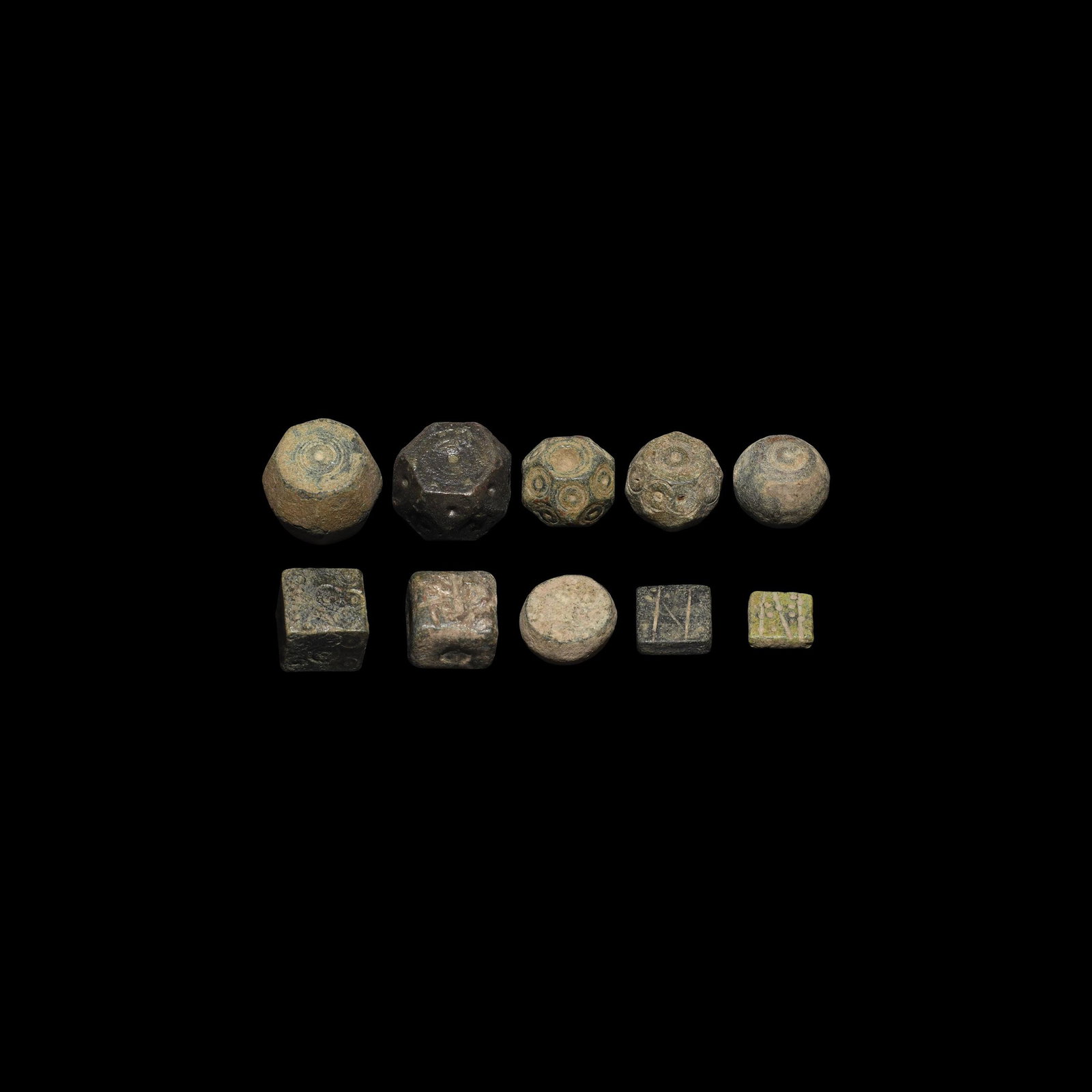 Byzantine Weight Collection: Mainly 10th century AD. A mixed group of bronze trade weights including polyhedral, barrel-shaped and cuboid types. 148 grams total, 9-20mm (1/4 - 3/4"). Ex an important Dutch collection; acquired on 