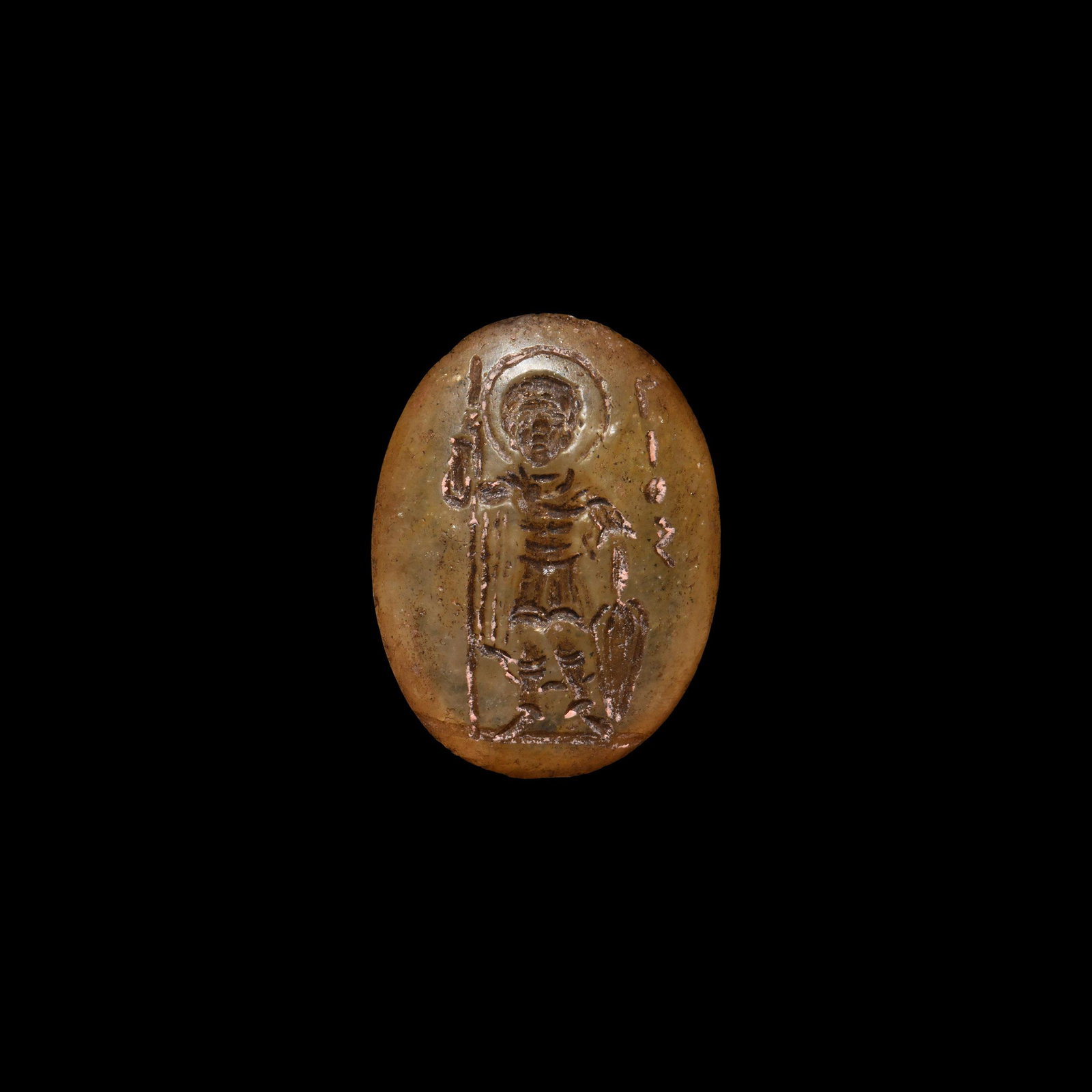 Byzantine Gemstone with Saint: 9th-10th century AD. A rock crystal gemstone with intaglio nimbate standing figure facing, holding a teardrop shield and a spear, wearing cuirass and greaves; legend '????' for '????????' (St. George"