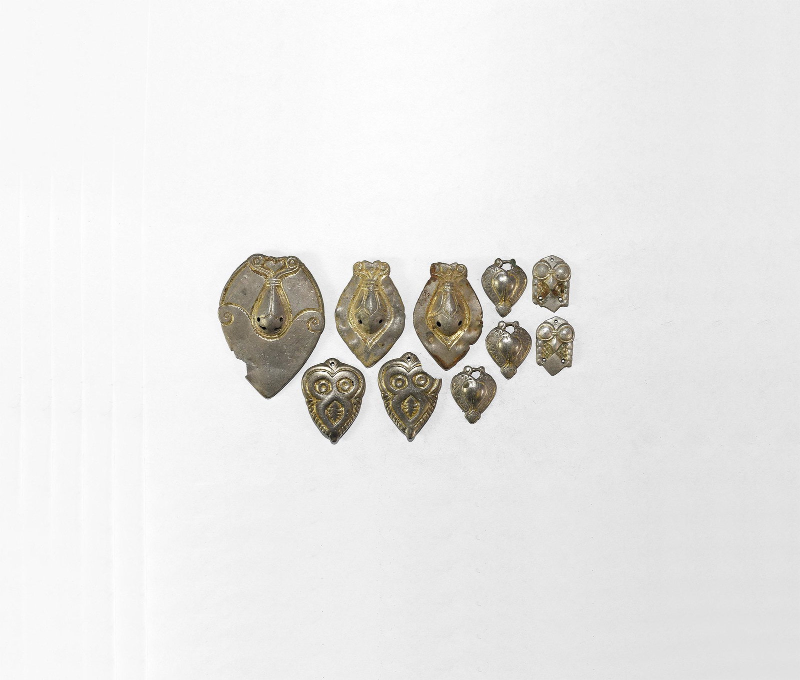 Byzantine Gilt Silver Mount Group: 10th century AD. A mixed group of parcel-gilt silver mounts, some pierced to accept laces or thongs. 59 grams total, 27-70mm (1 - 2 3/4"). From a London W1, UK, collection; acquired on the German art 