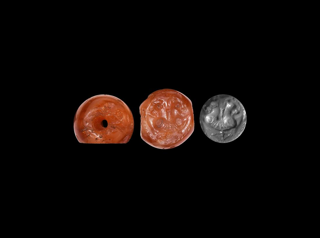 Sassanian Stamp Seal with Double-Headed Beast: 3rd-7th century AD. A carnelian stamp seal engraved with a double-headed beast with legs tucked under body; accompanied by a museum quality seal impression. 3.45 grams, 14mm (1/2"). Property of a Nort