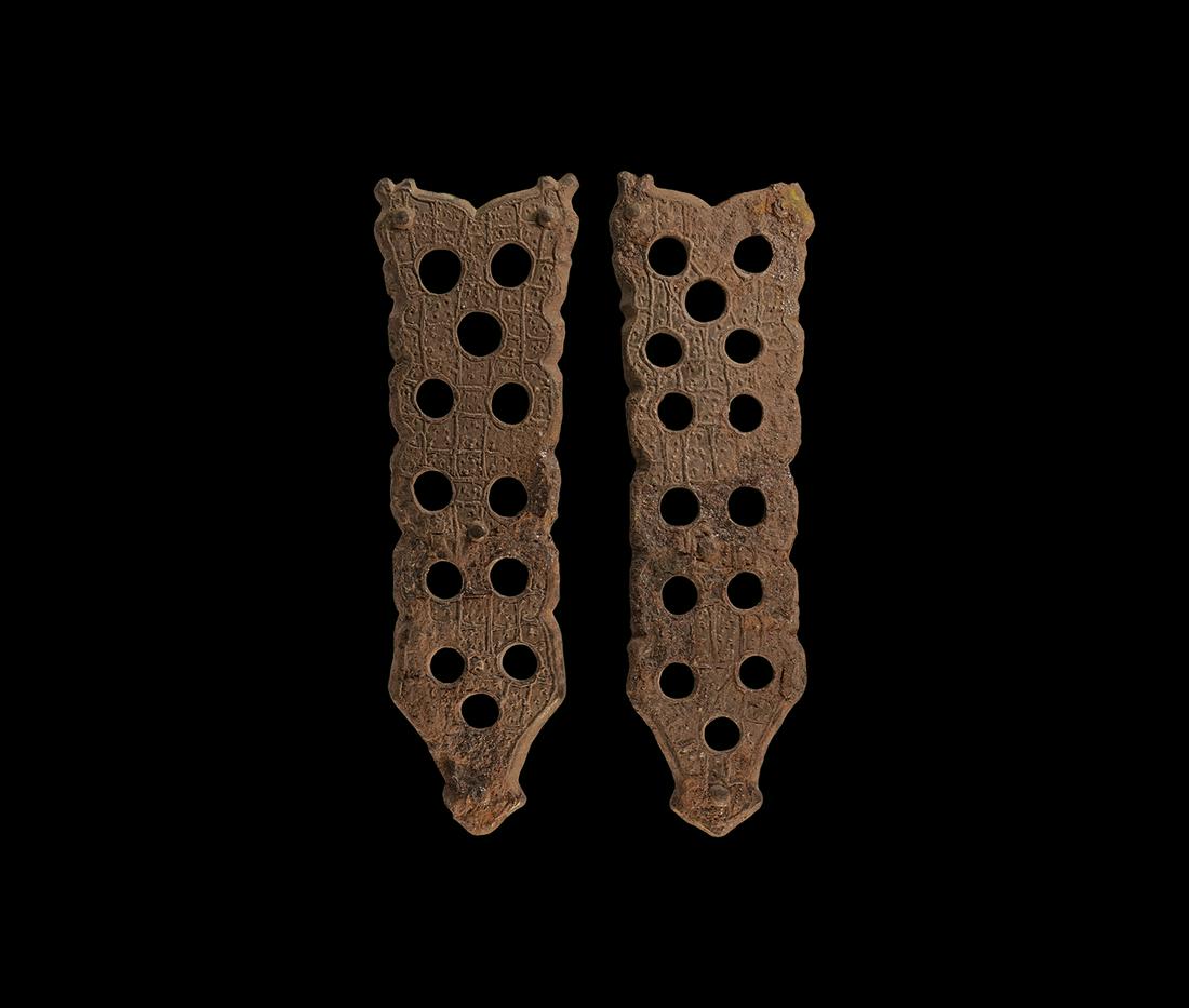 Viking Book Mount Pair: 11th-12th century AD. A matched pair of bronze mounts, each a tongue-shaped panel with attachment pins, openwork body with raised ladder detailing. 28.1 grams total, 93mm each (3 3/4"). Private collec