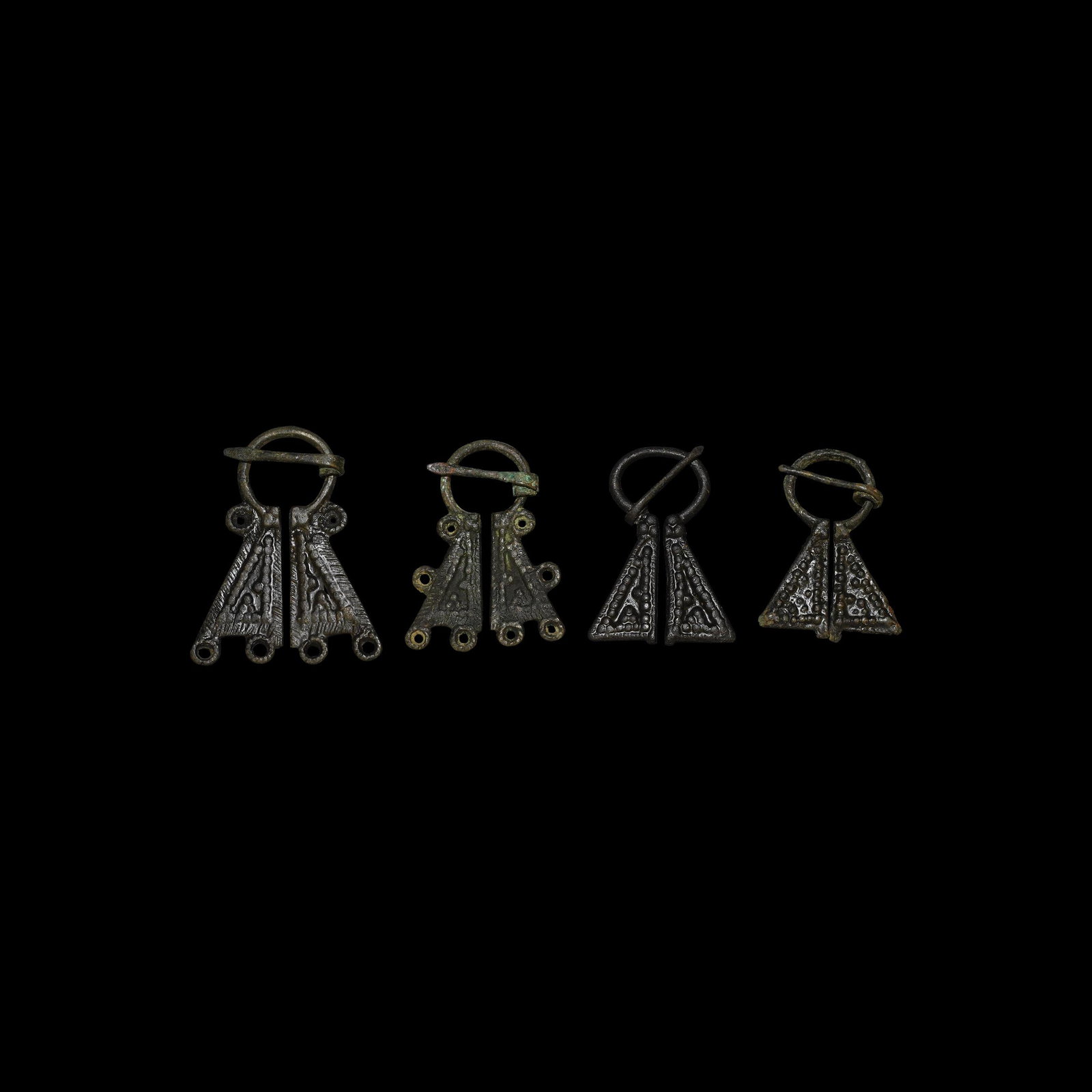 Viking Omega Brooch Collection: 12th century AD. A group of four bronze Mordvinian omega brooches each with coiled pin, two with loops for attaching thongs. See Sedov, B.B. Finno-Ugri i Balti v Epokhi Srednevekovija, Moscow, 1987, p
