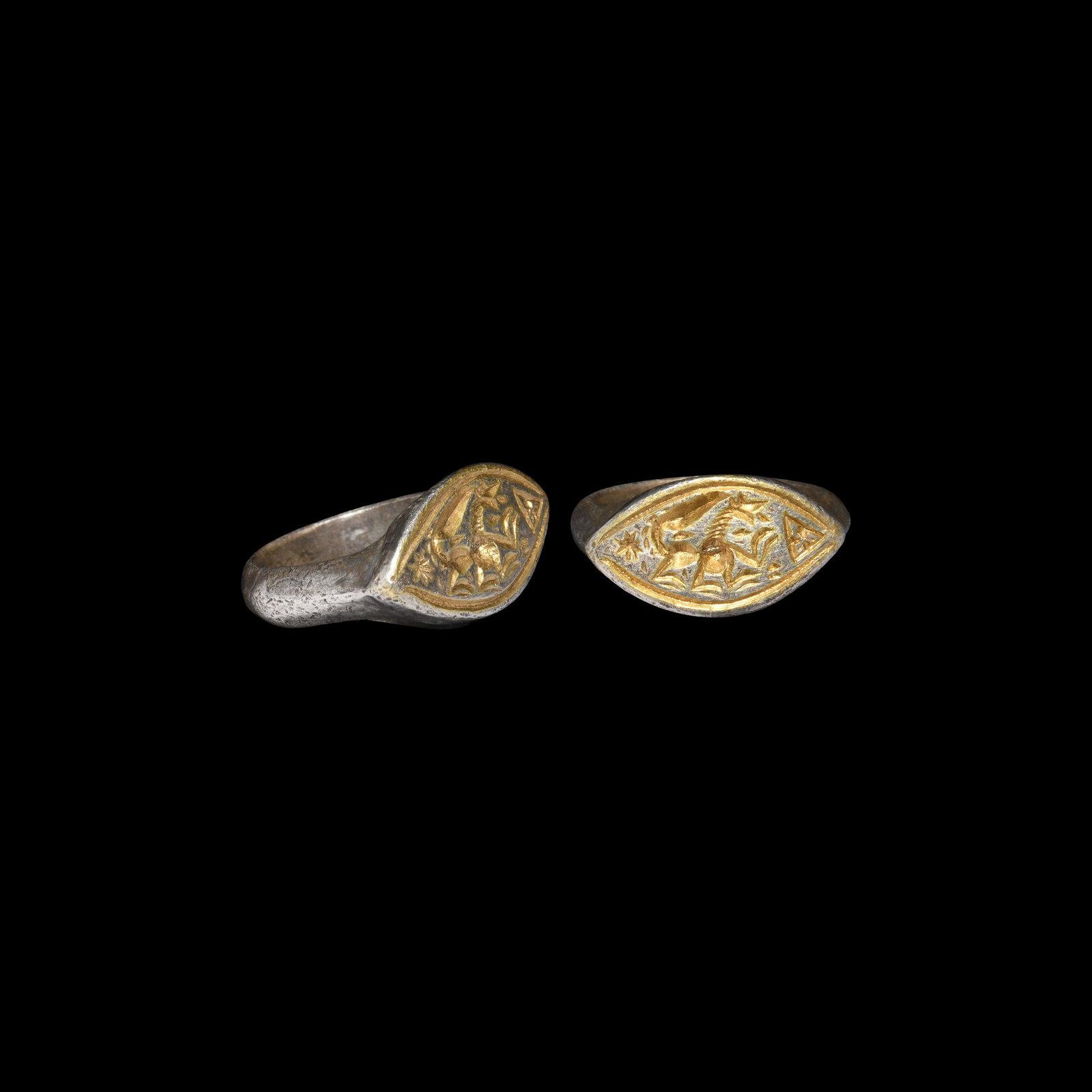 Medieval Gilt Silver Ring with Dragon: 13th-14th century AD. A silver finger ring with keeled hoop, scaphoid gilt bezel, intaglio design with advancing dragon(?), hexafoil and triangle with trefoil. 10 grams, 24.37mm overall, 19.37mm inter