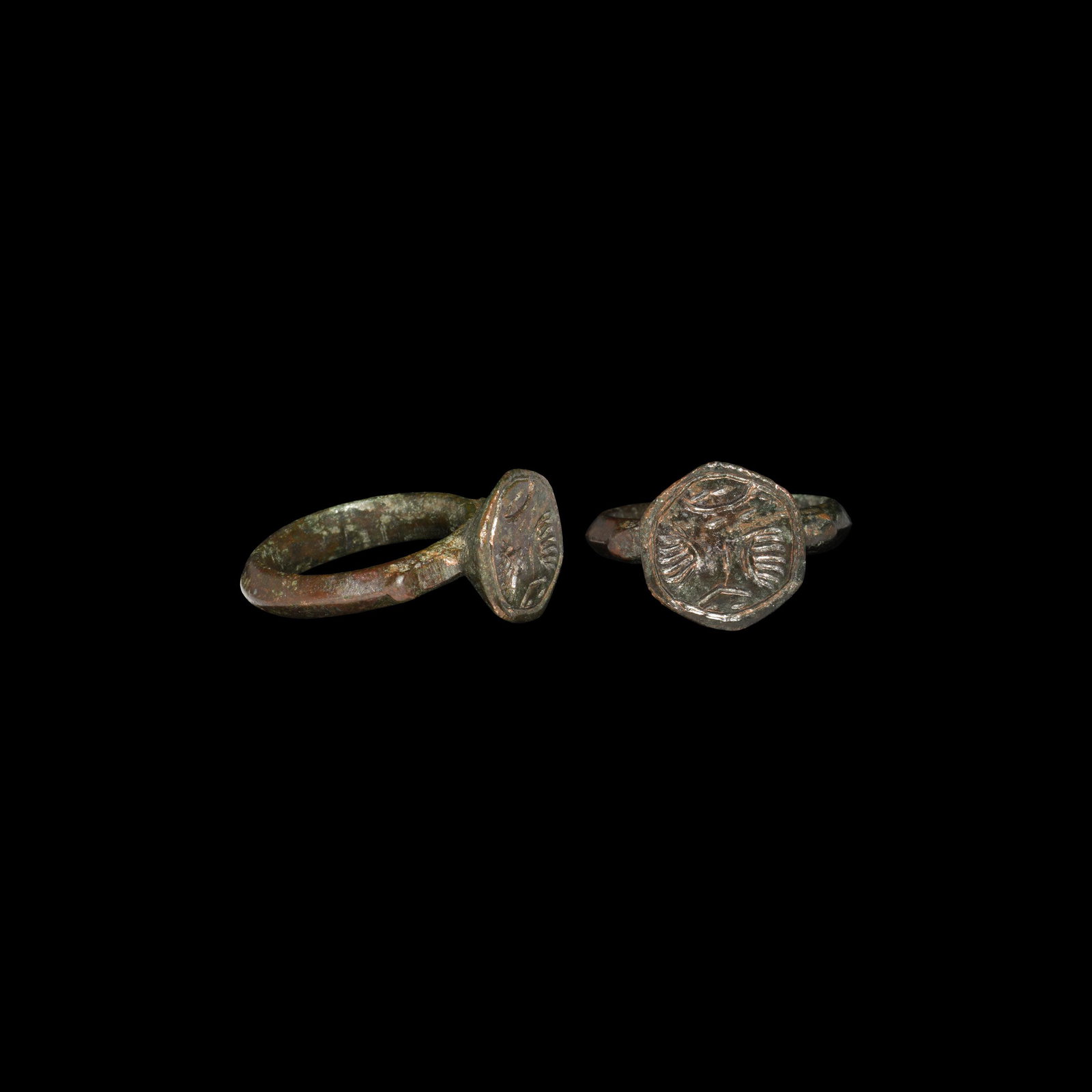 Medieval Ring with Wings: 14th century AD. A bronze finger ring with D-section hoop and spurs to the shoulders, hexagonal cup bezel with intaglio device of wings, pellets and other elements. Cf. Chadour, A.B. Rings. The Alice 
