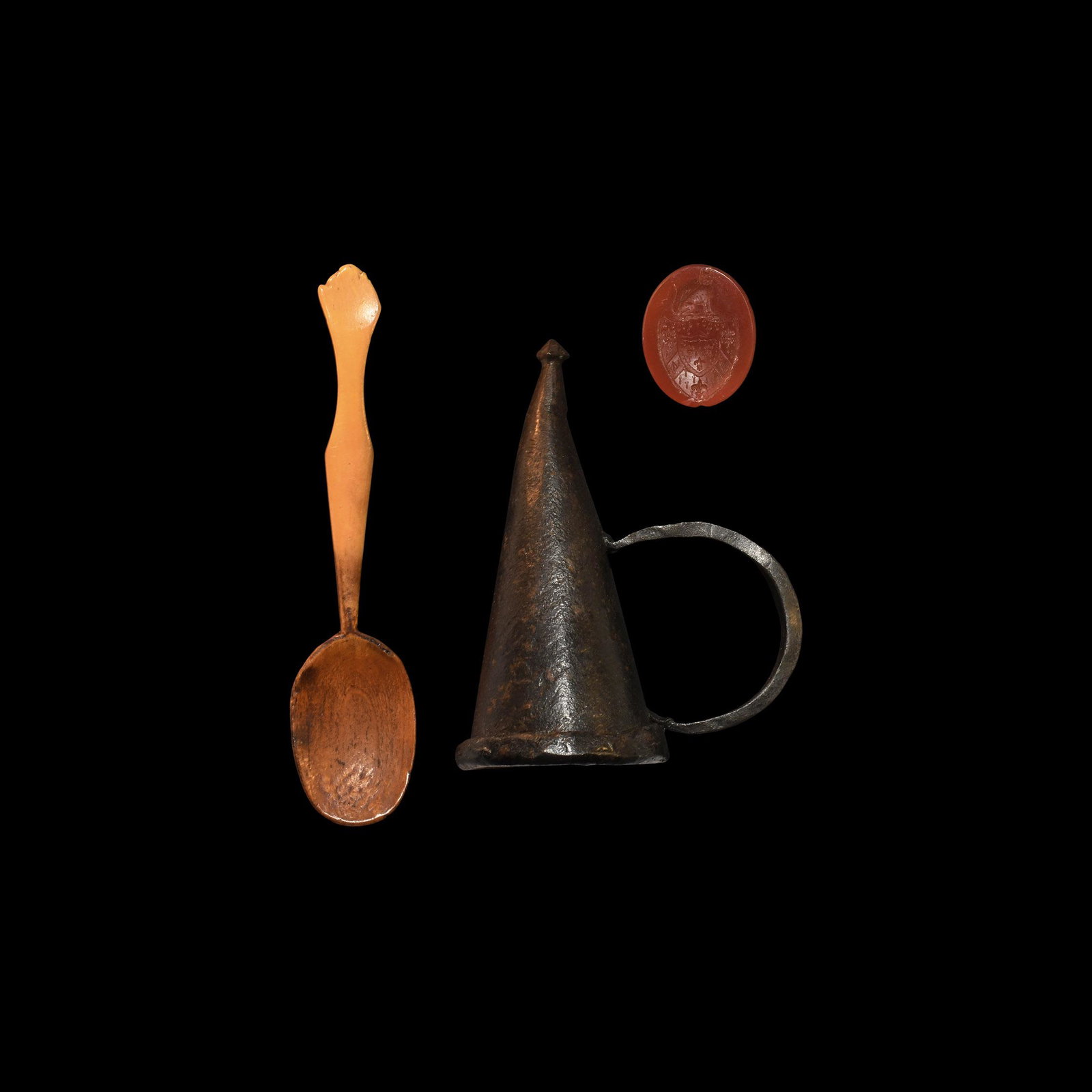 Medieval Candle Snuffer and Other Artefact Collection: 15th-19th century AD. A mixed group comprising: an iron candle-snuffer with loop handle; a bone spoon with one large, flat bowl and a smaller to the other end; a carnelian insert with intaglio armoria