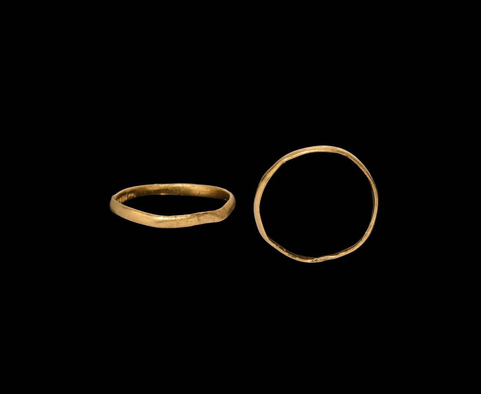 George III Gold Wedding Ring: 1760-1820 AD. A narrow gold band with indistinct hallmarks to the inner face (only the monarch's profile bust distinguishable), maker's mark 'WE' for William Eley of London. See Jackson, Sir C.J. Engl
