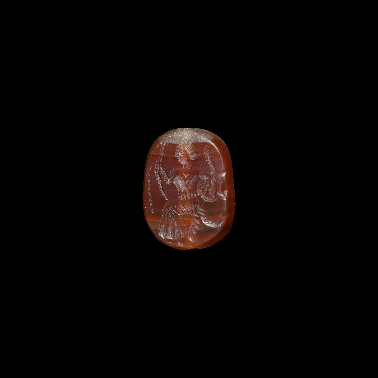 Post Medieval Gemstone with Seated Figure: 20th century AD. A carnelian gemstone with chamfered edge, intaglio seated female in loosely draped robe holding two serpents in the raised hands. 6.9 grams, 26mm (1"). Property of a London lady; from