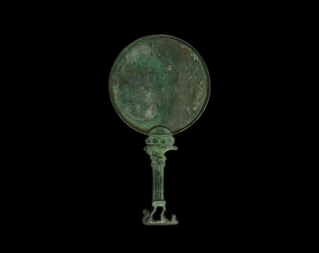 Large Scythian Mirror with Lion and Stag: 5th-4th century BC. A bronze mirror, Scythian-Olbian type, with oval face with reflective surface; handle with reclining stag with large antlers back along the body; fluted column below with standing 