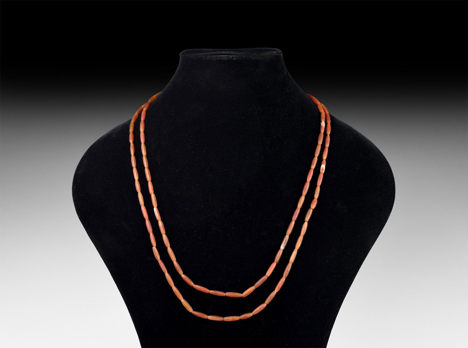 Roman Carnelian Bead Necklace String: 1st-3rd century AD. A restrung necklace of fusiform carnelian beads. 32 grams, 134cm (53"). Property of a West London gentleman; his collection formed in the late 1980s-early 1990s. [No Reserve]