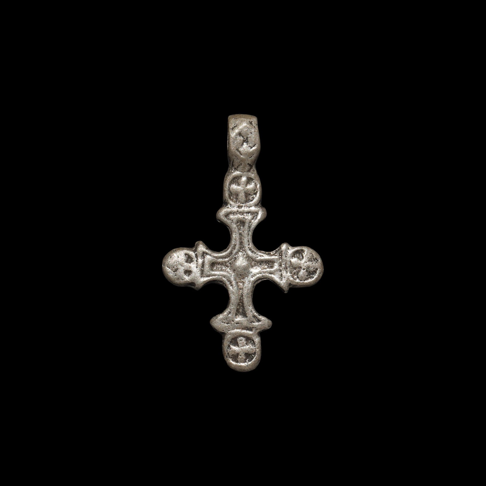 Byzantine Silver Cross Pendant: 10th-12th century AD. A silver cross bottony pendant with central cross cleché, equal-armed cross within a circular border to each arm; integral suspension loop. 5.21 grams, 36mm (1 1/2"). Property o