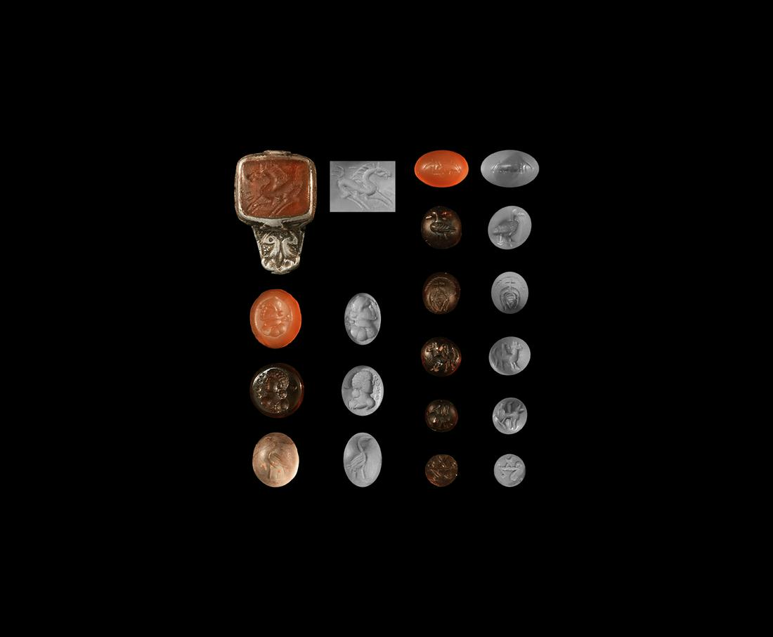 Western Asiatic Sassanian Gemstone Group: 3rd-7th century AD. A mixed group of carnelian, garnet and other cloisons and cabochons with intaglio motifs including profile bust, tamga, bird and others, and a carnelian cloison in a silver mount f