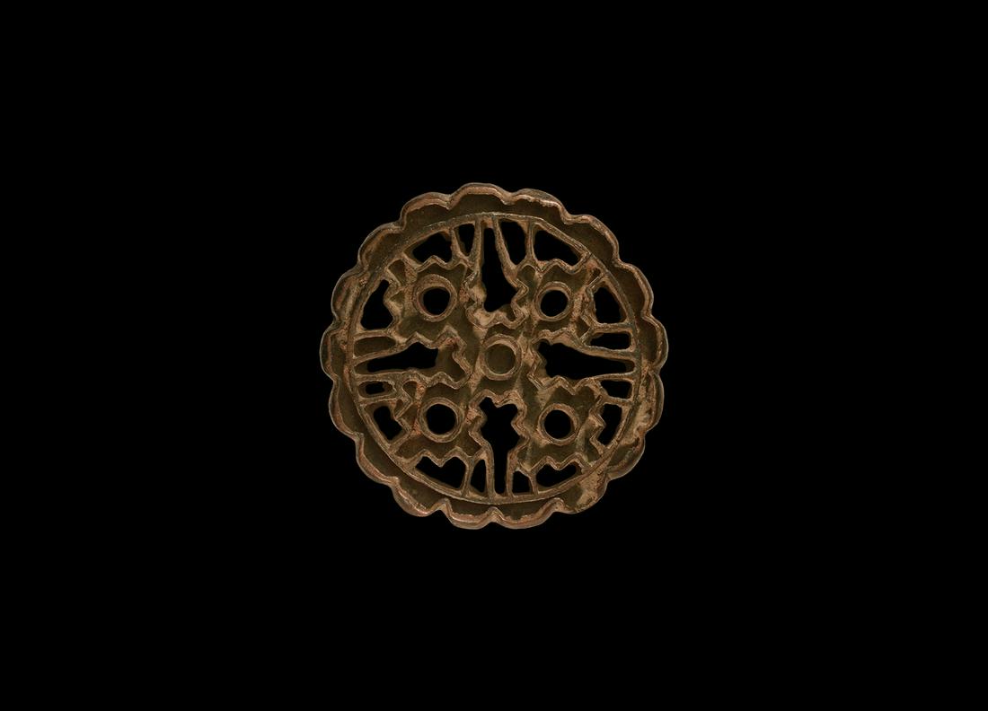 Western Asiatic Floral Stamp Seal: 23rd-20th century BC. A bronze discoid stamp with openwork design, accompanied by a typed and signed note by W.G. Lambert, late Professor of Assyriology, University of Birmingham, 1970-1993, which sta