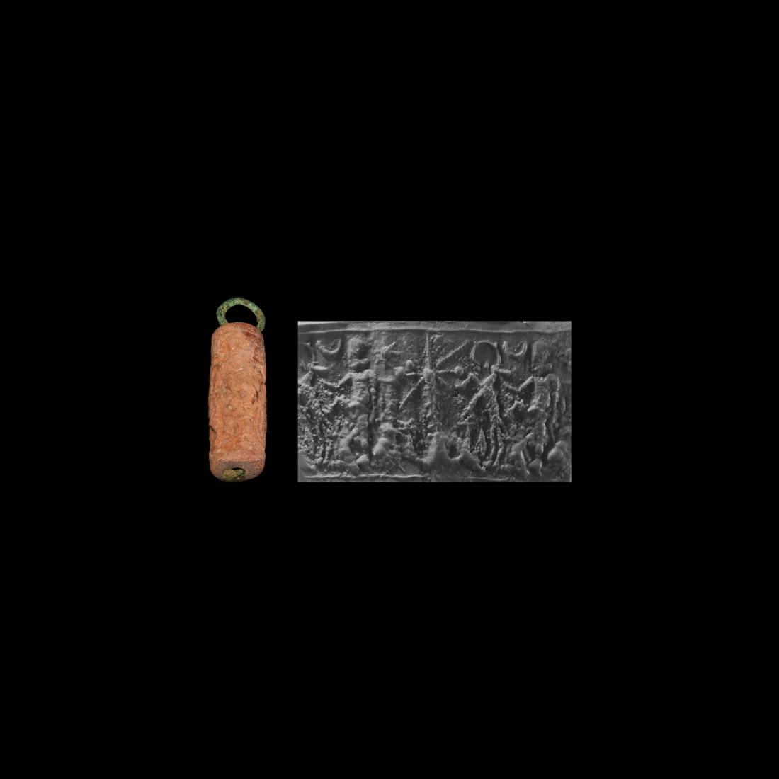 Western Asiatic Cylinder Seal: 3rd-2nd millennium BC. A carved pink limestone cylinder seal with two flat rims pierced through the centre receiving a copper-alloy suspension bar and loop; featuring a stylised tree(?) flanked by sta