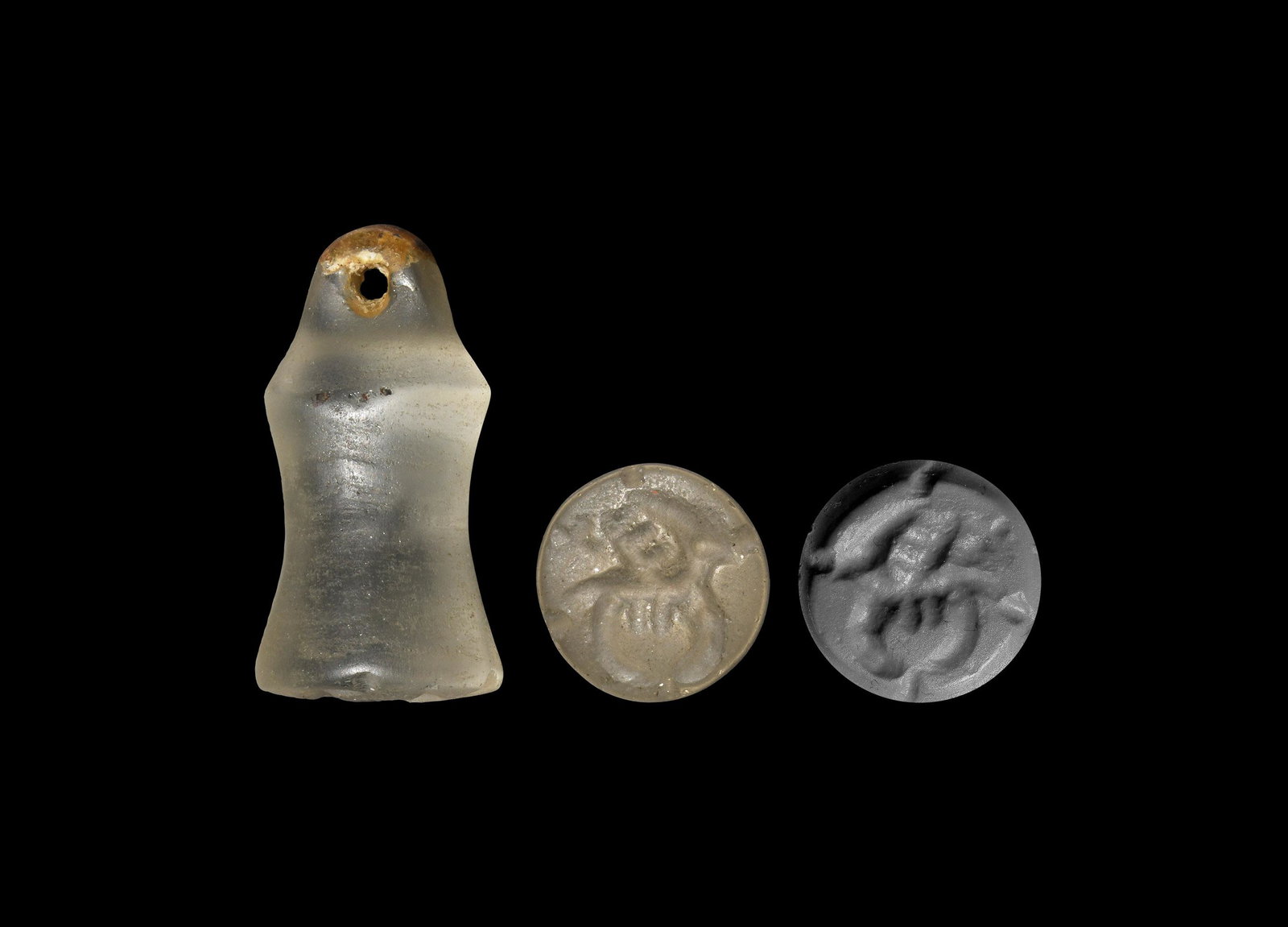 Western Asiatic Crystal Seal: 1st millennium BC. A carved bell-shaped rock crystal seal with pierced suspension lug, intaglio figure of a deer with arrows piercing the body; accompanied by a museum-quality impression. 11.4 grams, 