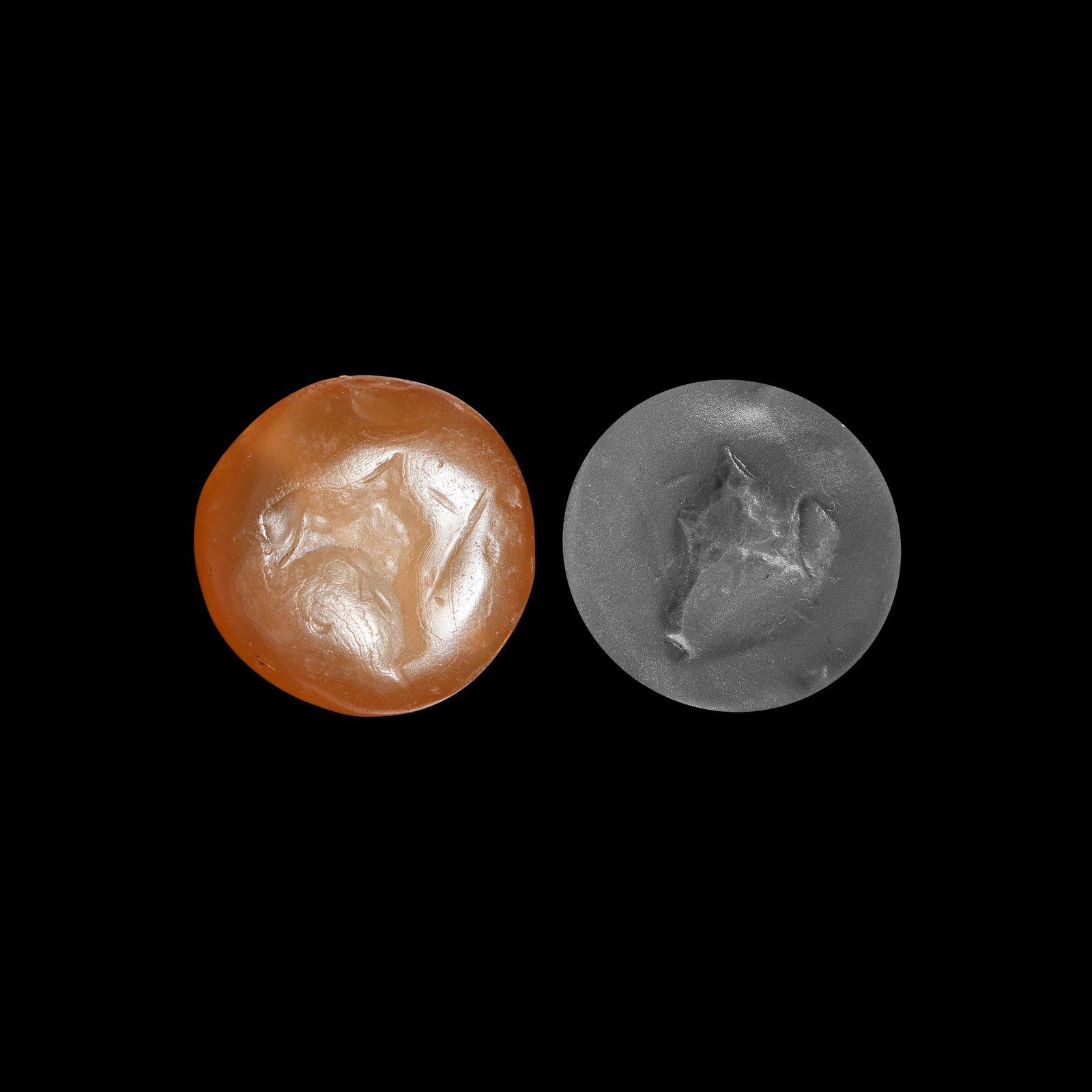 Western Asiatic Stamp Seal: 2nd millennium BC. A carnelian plano-convex stamp seal with abraded design to the flat face, perhaps a lion. 11.3 grams, 25mm (1"). Property of a Bristol collector; formerly part of his father's colle