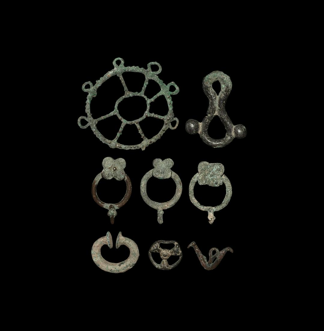 Western Asiatic Artefact Group: Mainly 1st millennium BC. A mixed bronze group comprising: loop closure with lateral bulbs; c-shaped fastener with disc finials; three annular belt fasteners with rosette; a trefoil ring with central 