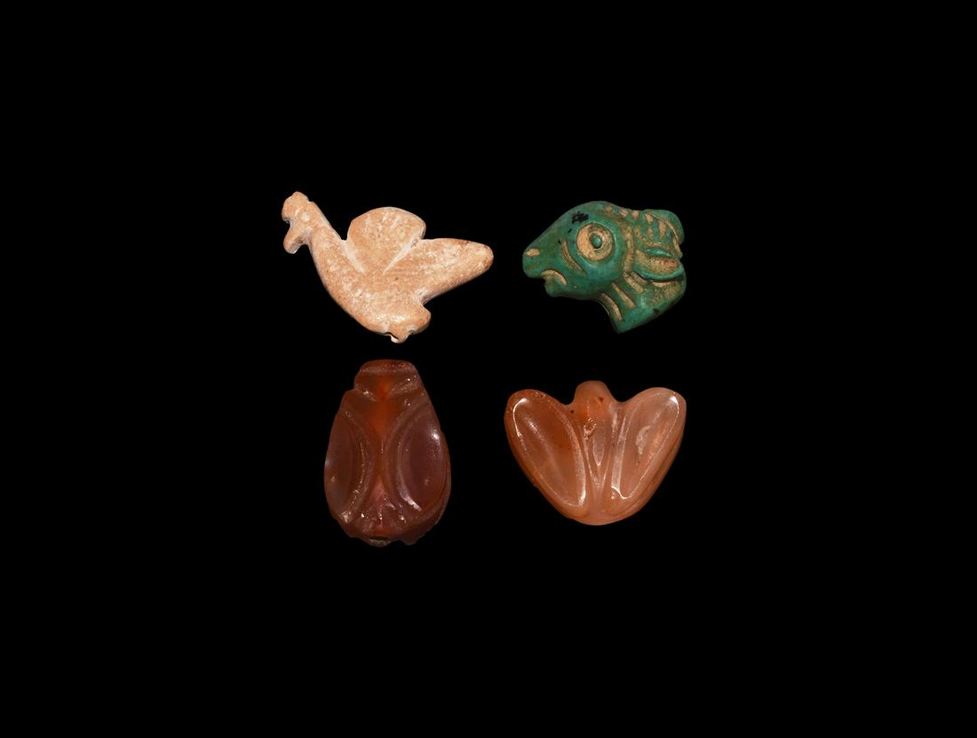 Western Asiatic Animal Amulet Collection: 2nd-1st millennium BC. A mixed group of amulets comprising: a bifacial carnelian cicada bead; one similar with wings spread, pierced for suspension as a pendant; a calcite(?) plaque of a bird; a turqu