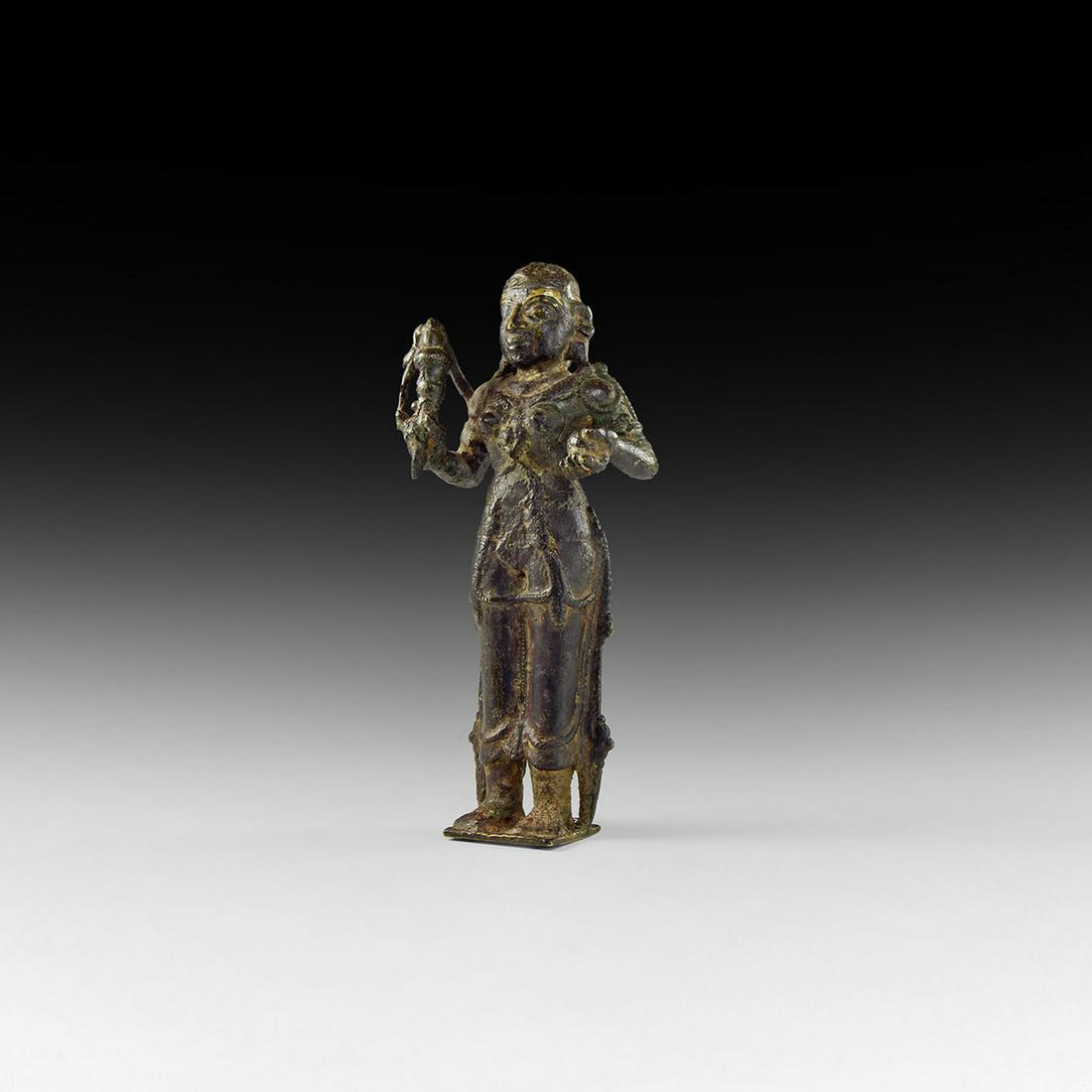 Indian Bhudevi Goddess Statuette: 18th century AD. A bronze statue of the Hindu goddess Bhudevi, the earth goddess and a consort of Vishnu, standing on a square base, wearing necklaces, anklets and bracelets, her hair drawn back into