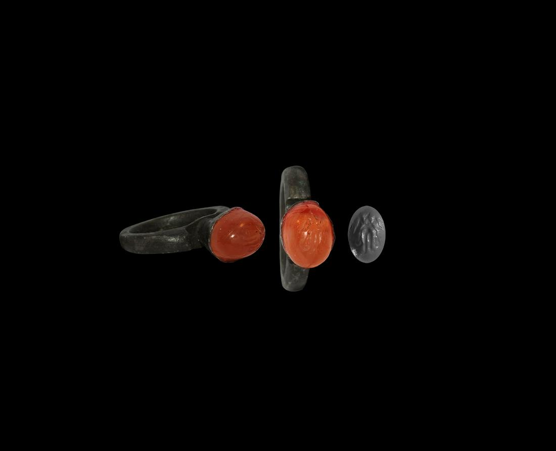 Islamic Silver Ring with Figural Gemstone: 19th century AD. A silver finger ring comprising a D-section hoop with scooped shoulders, trumpet bezel with inset carnelian cabochon, intaglio standing figure. Cf. Chadour, A.B., Rings. The Alice and