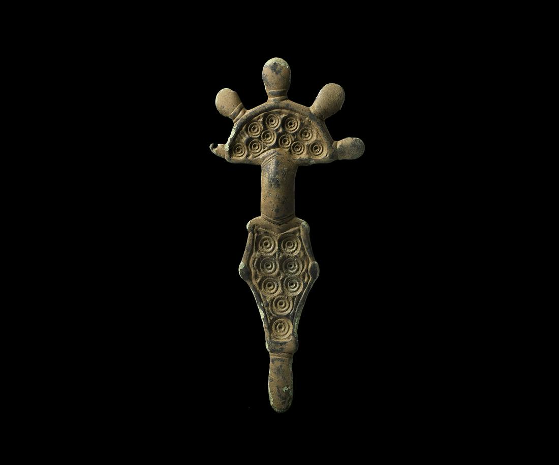 Visigothic Radiate-Headed Brooch: Early 6th century AD. A bronze radiate-headed bow brooch with D-shaped headplate and concentric circular patterns, radiating lugs to the upper edge, shallow bow with vertical ribs; a tongue-shaped foo