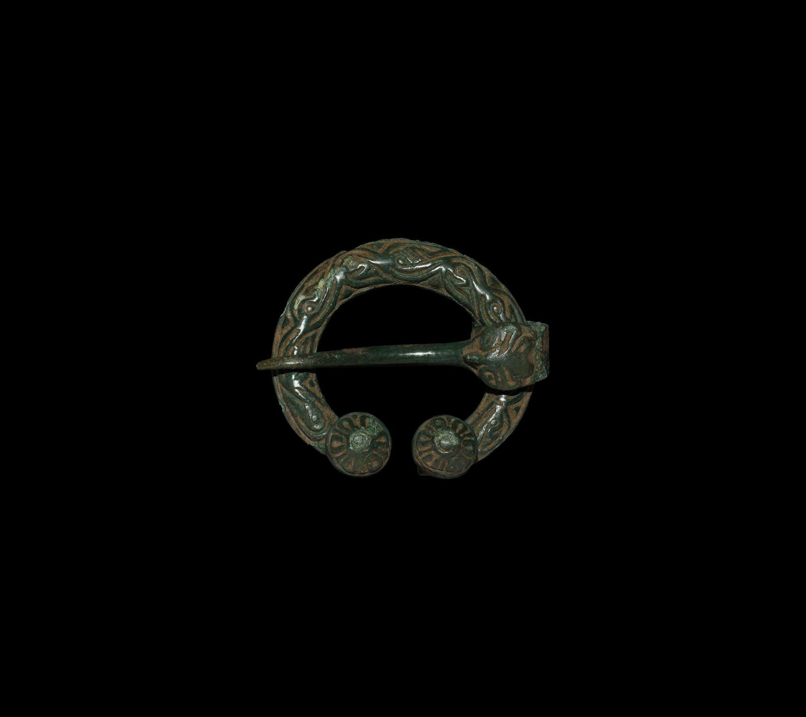 Viking Penannular Brooch with Beast Mask: 10th-12th century AD. A bronze penannular brooch with interlaced scroll-work and domed decorated finials; round-section pin with flat band and beast head. 15.2 grams, 43mm (1 3/4"). From a London W1, 