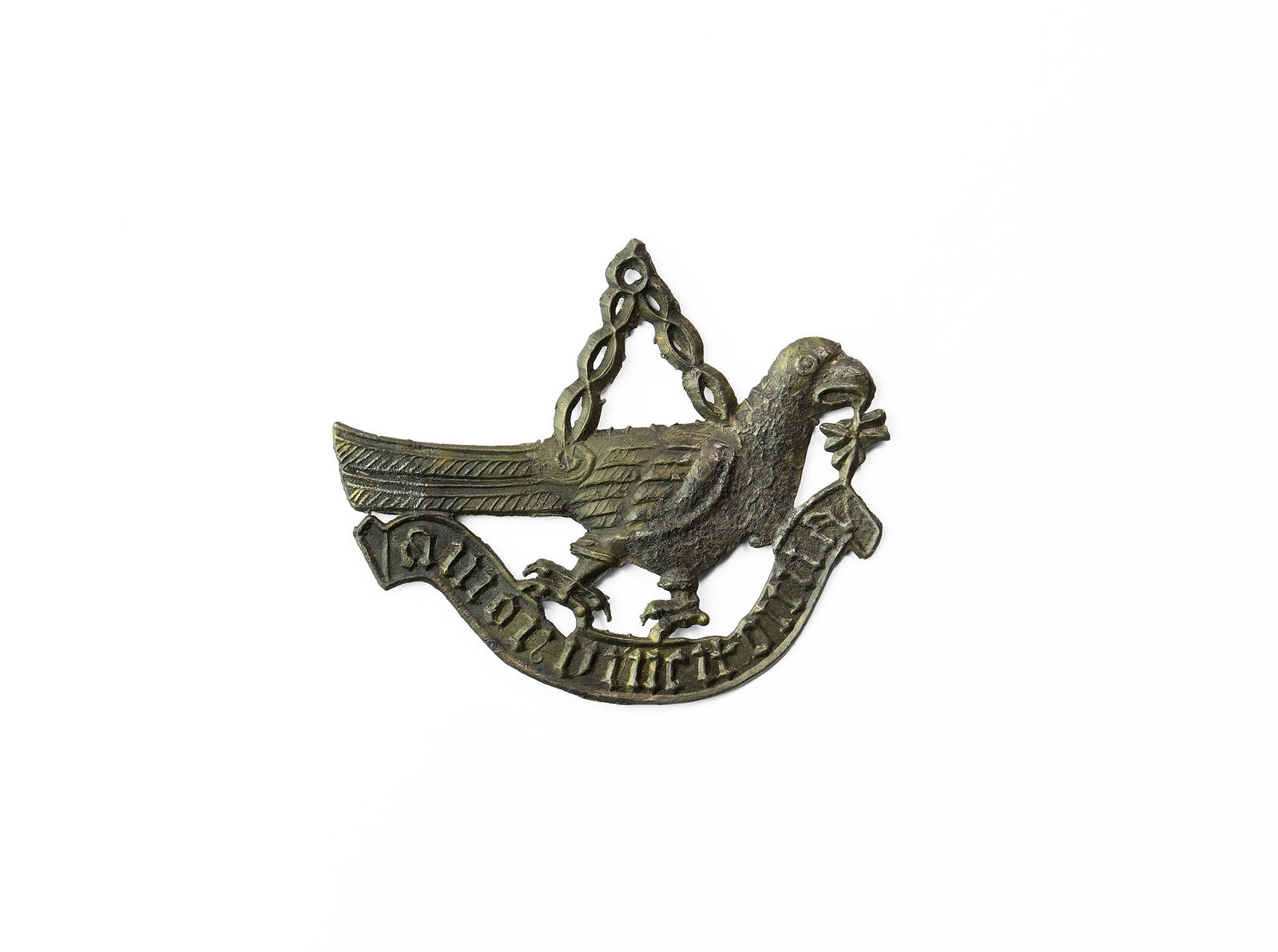 Medieval 'Love Conquers All' Pilgrim's Badge: 14th century AD. A pewter pilgrim's badge of a bird (dove?) with an olive branch in its mouth, V-shaped chain to its back, scroll with motto 'amor uincit omia[sic]' for amor vincit omnia 'love conquer