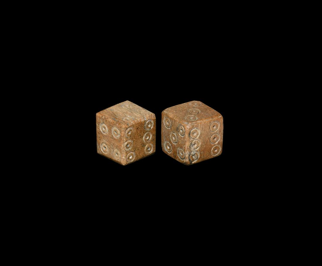 Roman Bone Dice Pair: 1st-3rd century AD. A pair of cuboid bone dice, each with ring-and-dot markings arranged 1:6, 2:3, 4:5. 5.08 grams total, 11mm each (1/2"). Property of a Birmingham gentleman; previously in a private 
