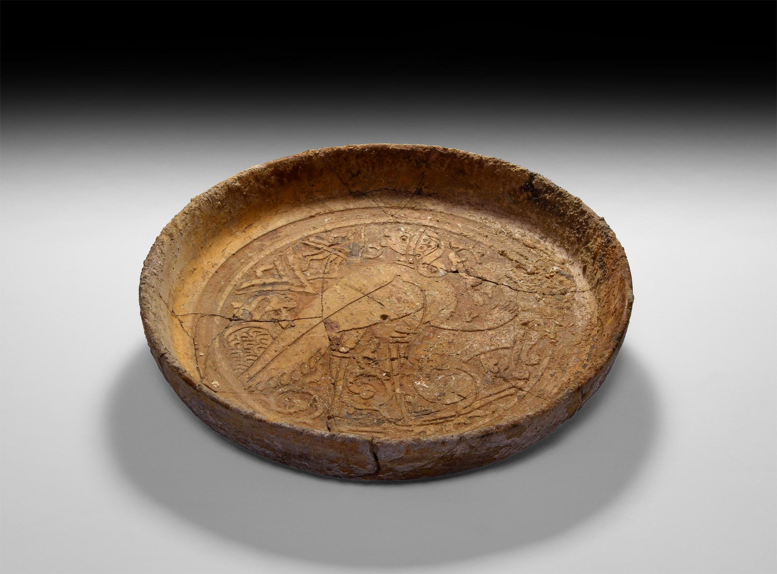 Byzantine Shipwreck Bowl with Stork: 10th-13th century AD. A shallow terracotta bowl with remains of cream glaze, a standing stork within a field of tendrils and other motifs to the centre. 845 grams, 25cm (10"). Property of a Suffolk ge