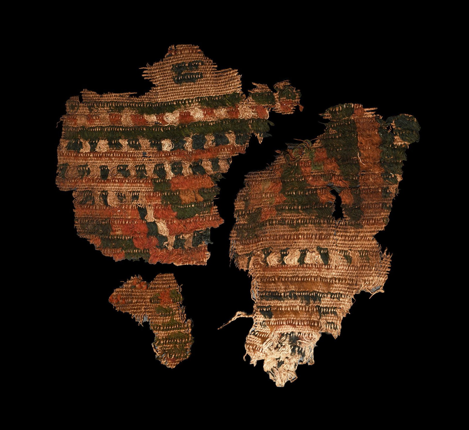 Byzantine Garment Fragment: 8th-9th century AD. A fabric fragment with vertical polychrome stripes, some stripes with bichrome fringes. 39 grams total including case, 22cm (8 1/2"). Property of a London gentleman; acquired in th