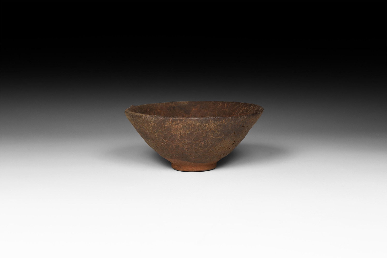 Chinese Song Jianyao 'Hare's Fur' Tea Bowl: Song Dynasty, 960-1127 AD. A conical ceramic bowl covered in a mottled dark glaze once streaked with fine russet-coloured 'hare’s fur' markings See Lili, F., Chinese Ceramics, Cambridge, 2011, for d